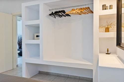 a walk in closet with white walls and shelves at Lagadia Village in Antiparos