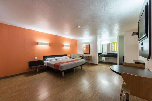 a large room with a bed and a television at Motel 6-Uvalde, TX in Uvalde