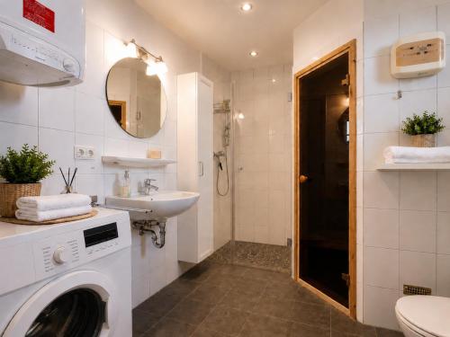 a bathroom with a washing machine and a sink at Golsfjellet Apartment with Sauna in Gol