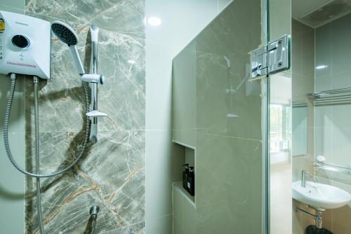 a bathroom with a shower and a sink at Sinai Rimtalay Hotel in Ban Nong Sanom
