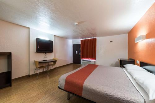 a hotel room with a bed and a television at Motel 6-Uvalde, TX in Uvalde