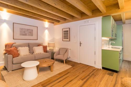 a living room with a couch and a table at Apartamentos La Botica in Comillas