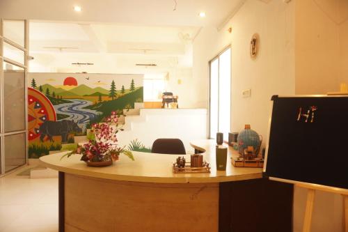 a room with a counter with a painting on the wall at Wanderpals Guwahati in Guwahati