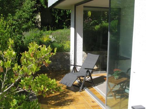 a chair sitting on a patio in front of a house at Ferienwohnung RoSi in Ebermannstadt