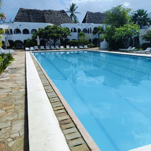 a swimming pool at the resort at Summer Studio Suit in Malindi