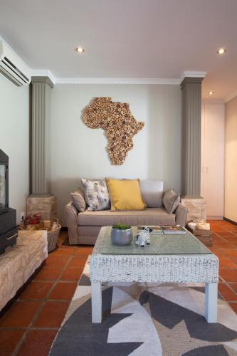 a living room with a couch and a table at Rest at Chabivin in Stellenbosch