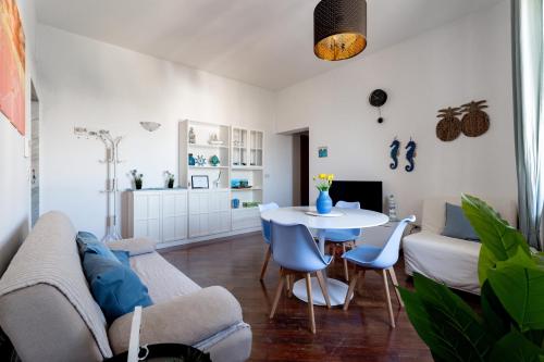 a living room with a couch and a table and chairs at Relax in Riva by MONHOLIDAY in Monopoli