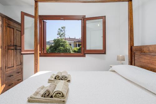 a bedroom with two beds and a window at Bella Vista su tavolara 4 in Porto San Paolo