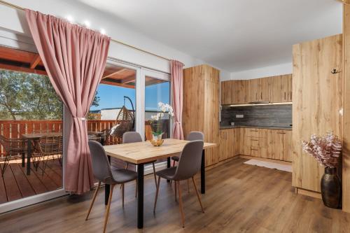 a dining room with a table and chairs at Rose Diamond Villa - cosy, large, family mobile home, free wifi and parking in Pakoštane