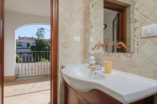 a bathroom with a sink and a mirror at Bella Vista su tavolara 4 in Porto San Paolo