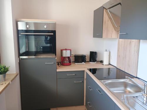 a kitchen with a refrigerator and a sink at Ferienwohnung RoSi in Ebermannstadt