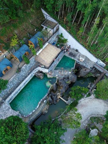 an overhead view of a pool of water with tents at Lotus Premium Lodge in Ha Giang