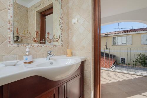 a bathroom with a sink and a mirror at Bella Vista su tavolara 5 in Porto San Paolo