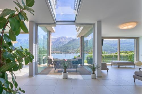 a living room with a view of the mountains at Villa Costanza- private heated pool, steam room & sauna - Bellagio Village Residence in Oliveto Lario