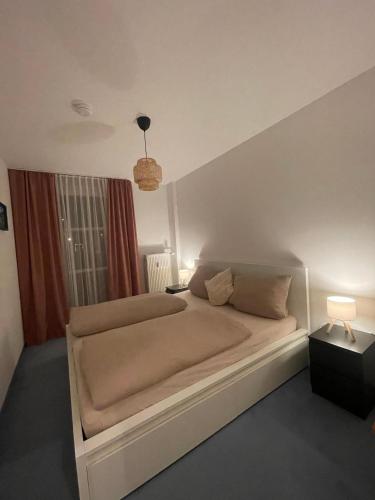 a bedroom with a large bed in a room at Waldliebe Spiegelhütte - Ferienwohnung am Bach in Lindberg