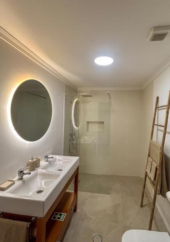 a bathroom with a sink and a shower at Refúgio dos Arrifes in Vila Baleira