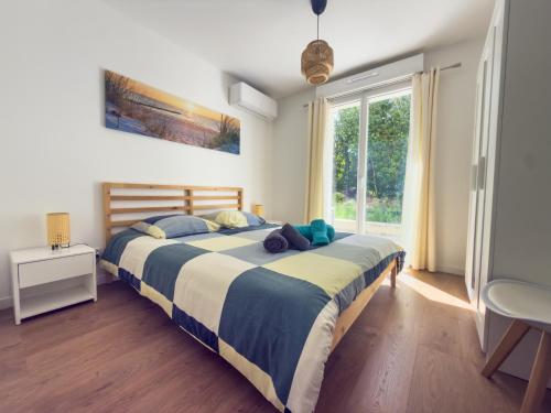 a bedroom with a large bed and a window at la Pascaline in Saint-Clément-de-Rivière