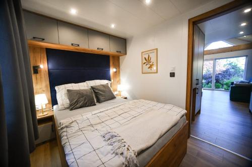 a bedroom with a large bed with a wooden headboard at Domek Klara in Wałbrzych