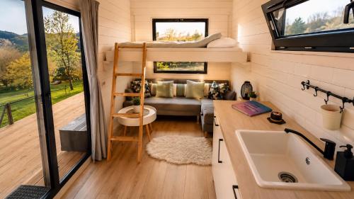 a tiny house with a bunk bed and a sink at The Tiny House in Râşnov
