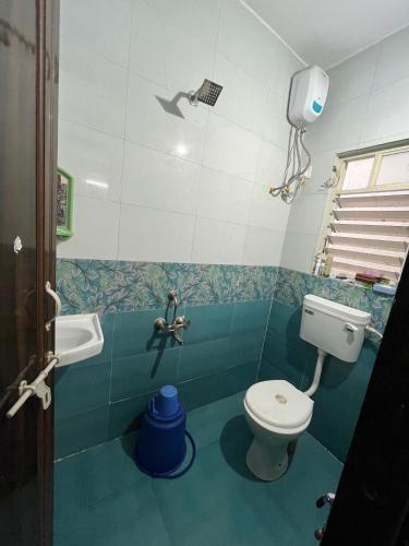 a bathroom with a toilet and a sink at Alpine Hostel Services in Pune