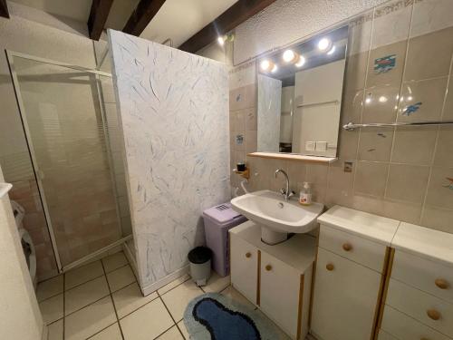 a bathroom with a sink and a shower and a toilet at L'Ancre Marine in Valras-Plage