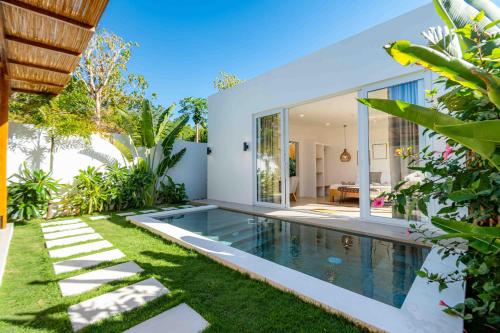 a swimming pool in the backyard of a villa at Villa Nindot - Private pool villas - Adults only in Siquijor