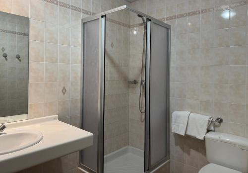 a bathroom with a shower and a toilet and a sink at Hébergement Centre Missionnaire Saint Jacques in Guiclan