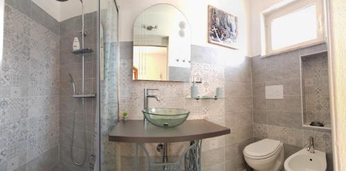 a bathroom with a sink and a shower and a toilet at B&B Relax Gonone in Cala Gonone
