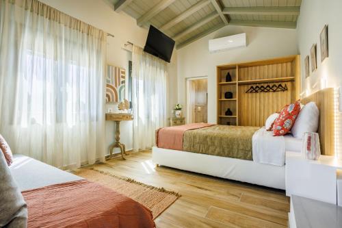 a bedroom with two beds and a window at Luxury Villa with Private Pool in Skopelos, Nature Retreat, Villa Pine Trees by Kardous in Alikias