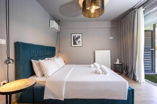 a bedroom with a large bed and a table at Athenean Pool Break in Athens