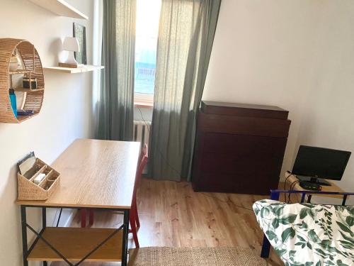 a living room with a table and a window at Grądy-Woniecko Place in Grądy