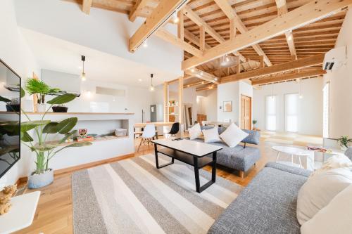 a living room with a couch and a table at タイガーMiyako in Miyako-jima