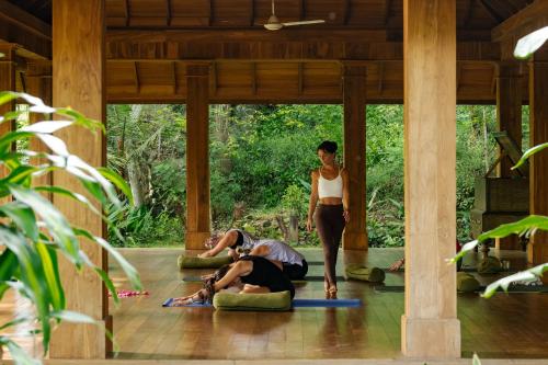 a group of people doing yoga in a pavilion at Rukgala Retreat in Digana