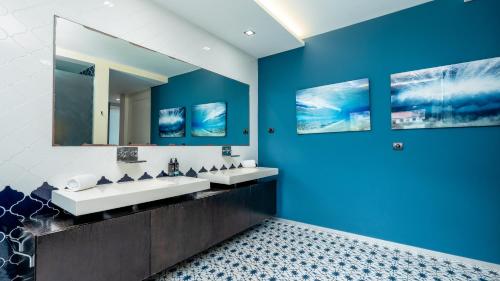 a bathroom with two sinks and a large mirror at Villa Skylark - by LovelyStay in Ponta do Sol