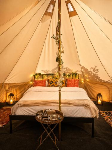 a bedroom with a tent with a bed and a table at Glamping Hive by Stream in Víska