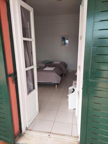 a room with a room with a bed and an open door at Avra in Alonnisos