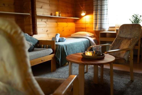 a room with a bed and a table and a chair at Kyyrönkaita in Kyyrö