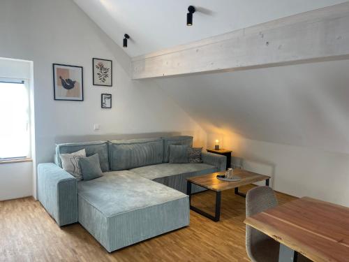a living room with a couch and a table at Schwarzfabrik in Bad Dürkheim