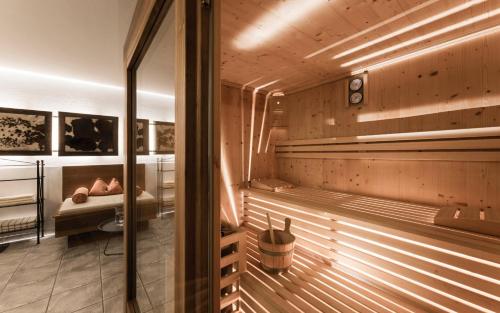 a sauna with a tub and a sink at Schenna Chalet - Chalet Oasis in Schenna