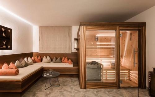 a room with two beds and a table in it at Schenna Chalet - Chalet Oasis in Schenna