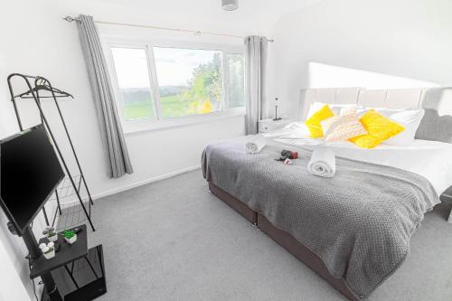 a bedroom with a bed and a flat screen tv at 3-bedroom pet friendly home with off road parking in Swansea
