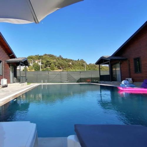 a swimming pool in a backyard with a house at Summertime Bungalows in Fethiye
