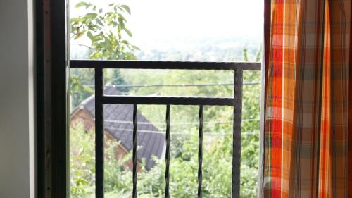 an open window with a view of a yard at Hillside Apartments in Révfülöp