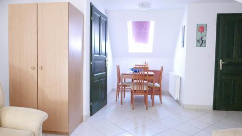 a dining room with a table and chairs at Hillside Apartments in Révfülöp