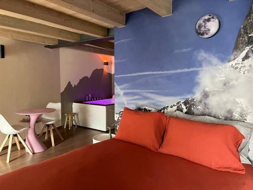 a bedroom with a bed and a wall with a mountain at Lo Blan Morgex in Morgex