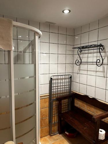 a room with a bench and a tiled wall at Ibón de la Sierra in El Pueyo de Jaca