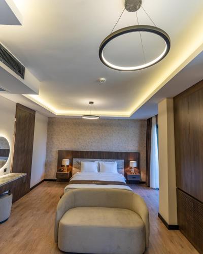 a large bedroom with a large bed and a ceiling at Rossa Marin Hotel in Darıca