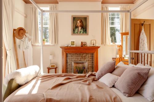 a bedroom with a bed and a fireplace at Home Farm in Oban