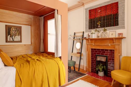 a bedroom with a bed and a fireplace at Home Farm in Oban