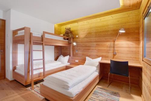 a room with two bunk beds and a desk at Chalet Oberjuval in Kastelbell-Tschars